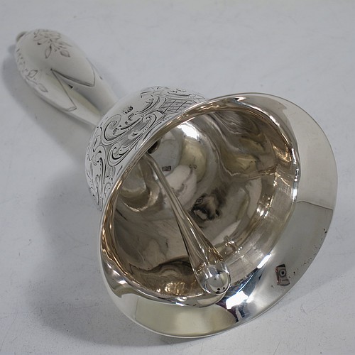 A very pretty Antique Victorian Sterling Silver table bell having a round baluster body with hand-engraved floral and scroll decoration, a tear-drop shaped handle with ball finial, with applied bead-edged borders, and an original silver clapper. Made by Hayne and Cater of London in 1863. The dimensions of this fine hand-made antique silver table bell are height 14 cms (5.5 inches), diameter at base 7 cms (2.75 inches), and it weighs approx. 132g (4.25 troy ounces). Please note that this item is crested.