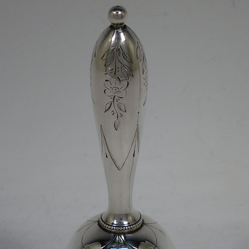 A very pretty Antique Victorian Sterling Silver table bell having a round baluster body with hand-engraved floral and scroll decoration, a tear-drop shaped handle with ball finial, with applied bead-edged borders, and an original silver clapper. Made by Hayne and Cater of London in 1863. The dimensions of this fine hand-made antique silver table bell are height 14 cms (5.5 inches), diameter at base 7 cms (2.75 inches), and it weighs approx. 132g (4.25 troy ounces). Please note that this item is crested.