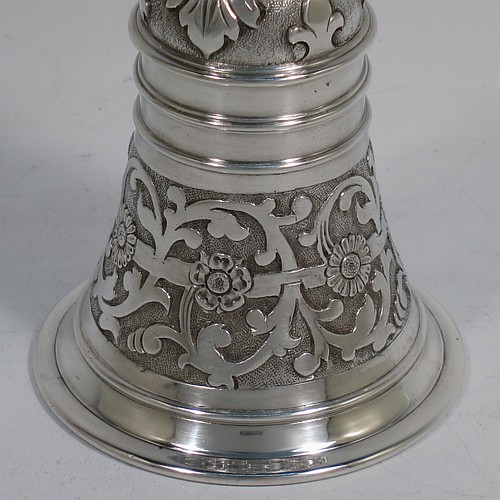 A very handsome, large and heavy sterling silver table bell having a round baluster body with hand-chased acanthus-leaf, scroll and floral decoration, a cast floral and scroll handle, and an original silver clapper. Made in London in 1967. The dimensions of this fine hand-made silver table bell are height 18 cms (7 inches), diameter at base 7 cms (2.75 inches), and it weighs approx. 361g (11.6 troy ounces).