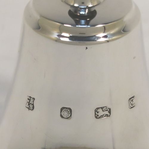 A handsome Sterling Silver table bell having a plain round body, a black stained wooden handle, and an original silver clapper on a chain. This elegant silver bell was made by Cooper Brothers and Sons of Sheffield in 1979. The dimensions of this fine hand-made silver table bell are height 11 cms (4.3 inches), diameter at base 6 cms (2.3 inches), and it weighs approx. 60g (1.9 troy ounces).