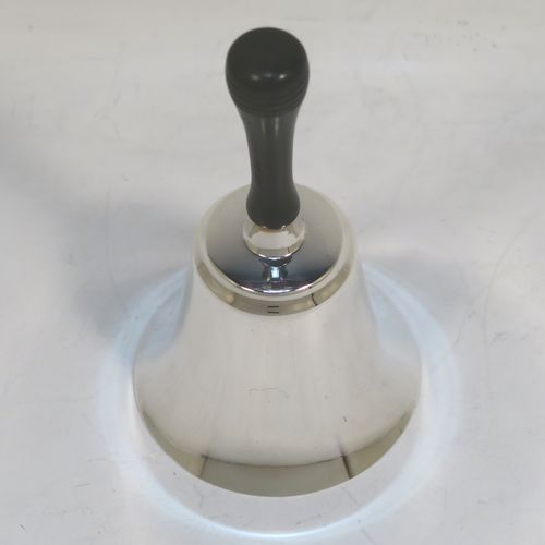 A handsome Sterling Silver table bell having a plain round body, a black stained wooden handle, and an original silver clapper on a chain. This elegant silver bell was made by Cooper Brothers and Sons of Sheffield in 1979. The dimensions of this fine hand-made silver table bell are height 11 cms (4.3 inches), diameter at base 6 cms (2.3 inches), and it weighs approx. 60g (1.9 troy ounces).