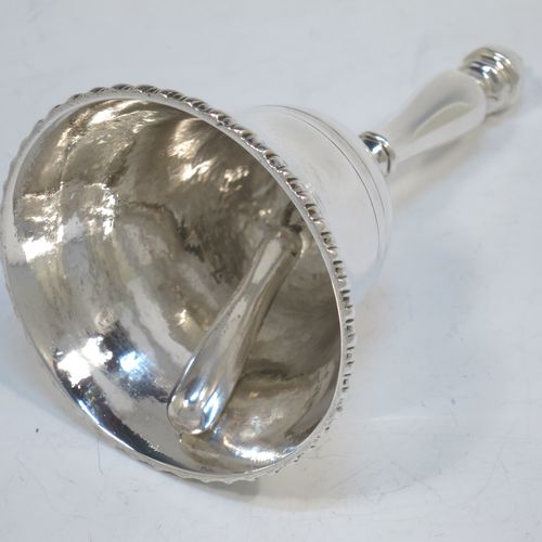A very elegant Antique Victorian Sterling Silver table bell having a plain round body with an applied gadroon border, a cast octagonal baluster handle, and an original silver clapper. Made by George John Richards of London in 1855. The dimensions of this fine hand-made antique silver table bell are height 13 cms (5 inches), diameter at base 7 cms (2.75 inches), and it weighs approx. 132g (4.3 troy ounces).