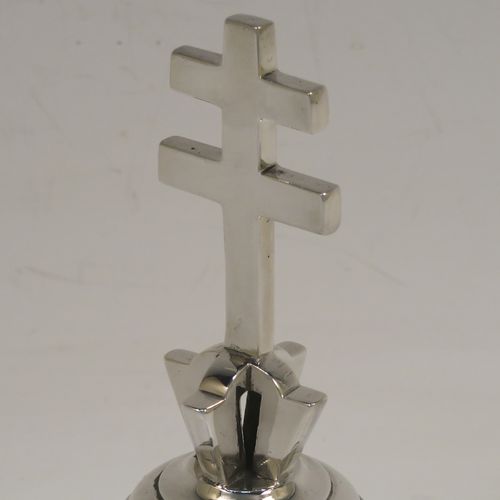 A very handsome and heavy Antique Edwardian Sterling Silver ecclesiastical style table bell having a plain round body with applied reeded borders, a cast two-bar cross of Lorraine (or cross of Anjou) handle, and an original silver clapper. This elegant antique silver table bell was made by Holland, Aldwinckle, and Slater of London in 1902. The dimensions of this fine hand-made antique silver table bell are height 13 cms (5 inches), diameter at base 7 cms (2.75 inches), and it weighs approx. 409g (13.2 troy ounces).