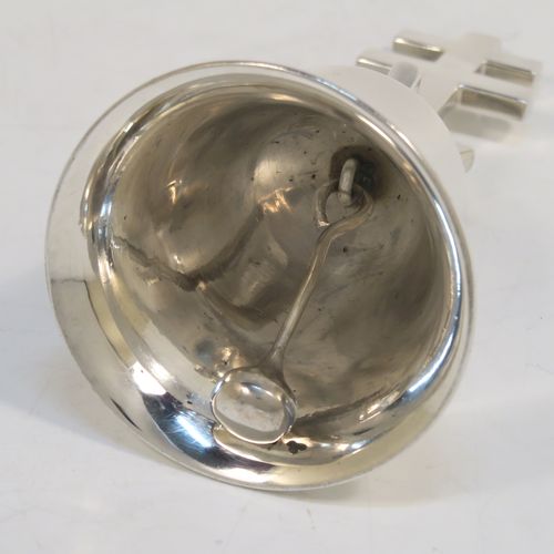 A very handsome and heavy Antique Edwardian Sterling Silver ecclesiastical style table bell having a plain round body with applied reeded borders, a cast two-bar cross of Lorraine (or cross of Anjou) handle, and an original silver clapper. This elegant antique silver table bell was made by Holland, Aldwinckle, and Slater of London in 1902. The dimensions of this fine hand-made antique silver table bell are height 13 cms (5 inches), diameter at base 7 cms (2.75 inches), and it weighs approx. 409g (13.2 troy ounces).