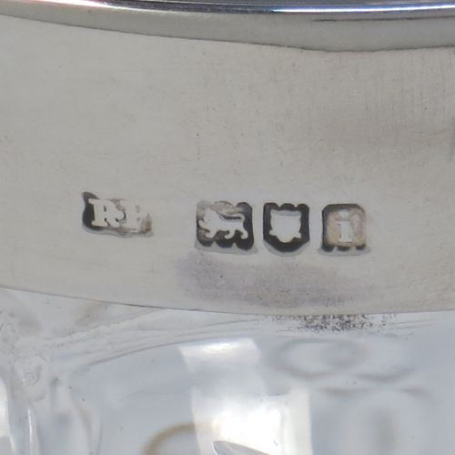 A pretty Antique Edwardian Sterling Silver and hand-cut crystal biscuit jar, having an unusual crystal body with hand-cut hobnail pattern panels with fluted corners, a plain round lift-off lid with a ball finial, a wire-work swing handle, and all sitting on a star-cut flat base. Made by Robert Pringle of London in 1904. The dimensions of this fine hand-made antique silver and crystal biscuit jar are height (excluding handle) 15 cms (6 inches), length 15 cms (6 inches), and width 13 cms (5 inches).