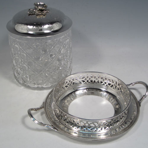 Antique Victorian sterling silver and hand-cut crystal biscuit jar, having a hobnail cut body, a lift-off lid with hand-engraved floral work and a cast flower finial, all sitting inside a two-handled plate with a hand-pierced gallery and bead-edge border. Made by Henry Wilkinson and Co., of Sheffield in 1867. The dimensions of this fine hand-made silver and crystal biscuit box are height 18 cms (6.3 inches), and diameter of base 17 cms (6.75 inches).