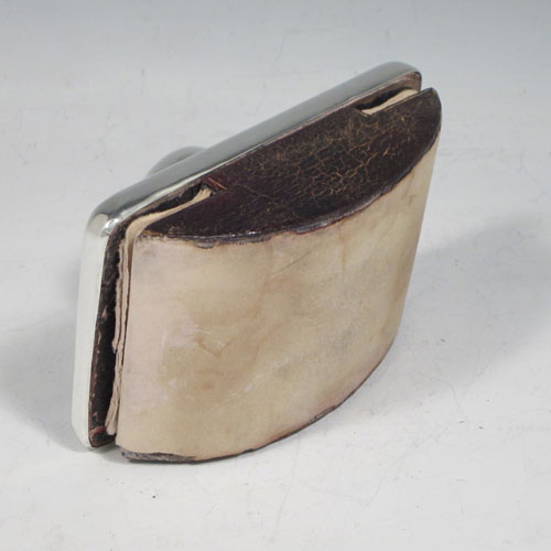 Antique Edwardian sterling silver Rocker Blotter, having a very plain rectangular body with rounded corners, a leather covered rocker base, and a plain round handle that screws in to secure the rocker base and blotting paper to the upper body. Made in Chester in 1906. The dimensions of this fine hand-made antique silver rocker blotter are length 11.5 cms (4.5 inches), height 6.5 cms (2.5 inches), and width 7.5 cms (3 inches).