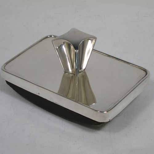 A very handsome Antique Victorian Sterling Silver Rocker Blotter, having a plain rectangular body with rounded corners, a wooden green felt covered rocker base, and an unusual scalloped handle that screws in to secure the rocker base and blotting paper to the upper body. Made by Daniel and Arter of Birmingham in 1901. The dimensions of this fine hand-made antique silver rocker blotter are length 11 cms (4.3 inches), height 6 cms (2.3 inches), and width 7.5 cms (3 inches).