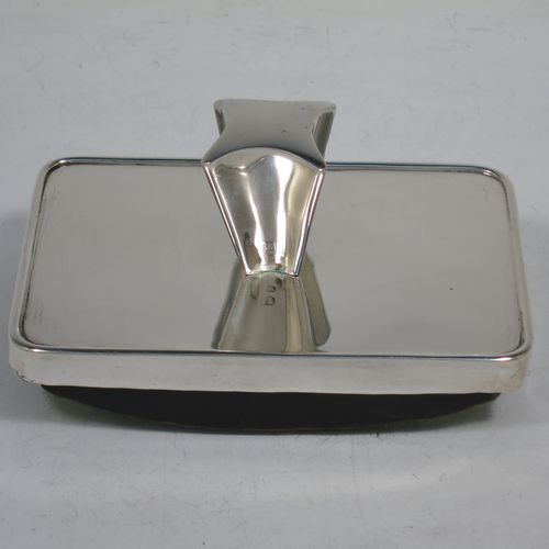 A very handsome Antique Victorian Sterling Silver Rocker Blotter, having a plain rectangular body with rounded corners, a wooden green felt covered rocker base, and an unusual scalloped handle that screws in to secure the rocker base and blotting paper to the upper body. Made by Daniel and Arter of Birmingham in 1901. The dimensions of this fine hand-made antique silver rocker blotter are length 11 cms (4.3 inches), height 6 cms (2.3 inches), and width 7.5 cms (3 inches).