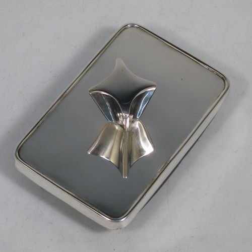 A very handsome Antique Victorian Sterling Silver Rocker Blotter, having a plain rectangular body with rounded corners, a wooden green felt covered rocker base, and an unusual scalloped handle that screws in to secure the rocker base and blotting paper to the upper body. Made by Daniel and Arter of Birmingham in 1901. The dimensions of this fine hand-made antique silver rocker blotter are length 11 cms (4.3 inches), height 6 cms (2.3 inches), and width 7.5 cms (3 inches).