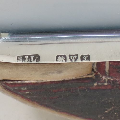 A handsome Antique Sterling Silver Rocker Blotter, having a very plain rectangular body with rounded corners, a leather covered rocker base, and a plain round handle that screws in to secure the rocker base and blotting paper to the upper body. Made by Stokes and Ireland of Chester in 1911. The dimensions of this fine hand-made antique silver rocker blotter are length 10 cms (4 inches), height 6 cms (2.3 inches), and width 6.5 cms (2.5 inches).