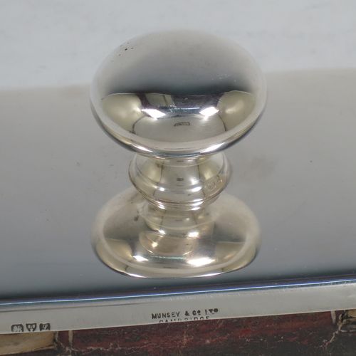 A handsome Antique Sterling Silver Rocker Blotter, having a very plain rectangular body with rounded corners, a leather covered rocker base, and a plain round handle that screws in to secure the rocker base and blotting paper to the upper body. Made by Stokes and Ireland of Chester in 1911. The dimensions of this fine hand-made antique silver rocker blotter are length 10 cms (4 inches), height 6 cms (2.3 inches), and width 6.5 cms (2.5 inches).