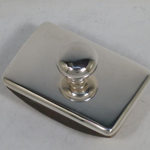 A handsome Antique Sterling Silver Rocker Blotter, having a very plain rectangular body with rounded corners, a leather covered rocker base, and a plain round handle that screws in to secure the rocker base and blotting paper to the upper body. Made by Stokes and Ireland of Chester in 1911. The dimensions of this fine hand-made antique silver rocker blotter are length 10 cms (4 inches), height 6 cms (2.3 inches), and width 6.5 cms (2.5 inches).