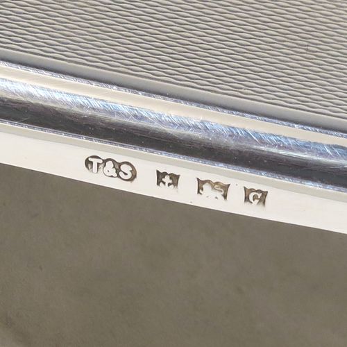 A handsome and unusual Sterling Silver Rocker Blotter, having a rectangular body with engine-turned decoration and plain chamfered borders, a plain round central handle, and a sprung steel plate held under tension that holds the blotting paper to the upper body. This beautiful silver rocker blotter was made by Turner and Simpson of Birmingham in 1956. The dimensions of this fine hand-made silver rocker blotter are length 15 cms (6 inches), height 5 cms (2 inches), width 8.5 cms (3.25 inches), and it weighs approx. 150g (4.8 ozt).