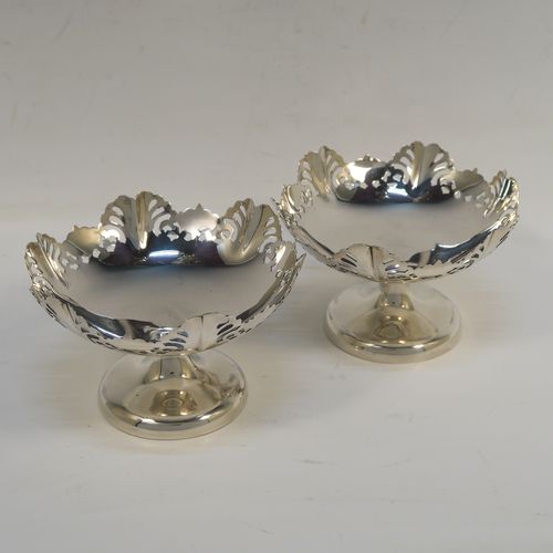 A pretty pair of Sterling Silver bon-bon dishes, having round bodies, with hand-pierced and wavey edge top borders, and sitting on plain round pedestal feet. These elegant silver bon-bon dishes were made by Emile Viner of Sheffield in 1958. The dimensions of these fine hand-made silver bon-bon dishes are height 7 cms (2.75 inches), diameter 11 cms (4.3 inches), and they weigh a total of approx. 212g (6.8 troy ounces).   