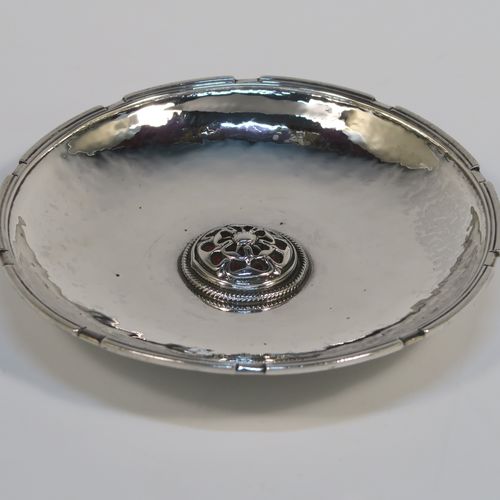 A beautiful and rare Antique Sterling Silver bon-bon dish, having a round hand-hammered body with an applied reeded border, a central applied and pierced Tudor rose with red enamelling and rope-twist border, and all sitting on a collet foot. This fantastic silver bon-bon dish was made by Omar Ramsden of London in 1924. The dimensions of this fine hand-made antique silver and enamelled dish are diameter 11 cms (4.3 inches), and it weigh approx. 87g (2.8 troy ounces). Importantly this item is engraved underneath with OMAR RAMSDEN ME FECIT.   