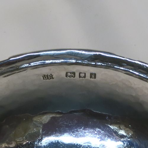 A beautiful and rare Antique Sterling Silver bon-bon dish, having a round hand-hammered body with an applied reeded border, a central applied and pierced Tudor rose with red enamelling and rope-twist border, and all sitting on a collet foot. This fantastic silver bon-bon dish was made by Omar Ramsden of London in 1924. The dimensions of this fine hand-made antique silver and enamelled dish are diameter 11 cms (4.3 inches), and it weigh approx. 87g (2.8 troy ounces). Importantly this item is engraved underneath with OMAR RAMSDEN ME FECIT.
