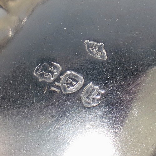 A very pretty Antique Victorian Sterling Silver pair of bon-bon baskets or dishes, having oval bodies with hand-pierced geometrical and scroll work decoration, an applied cast floral and scroll border, and sitting on matching pierced feet. Made by William Comyns of London in 1892. The dimensions of this fine hand-made pair of antique silver bon-bon dishes or baskets are length 16 cms (6.25 inches), width 12 cms (4.75 inches), height 7 cms (2.75 inches), and they weigh a total of approx. 328g (10.6 troy ounces).