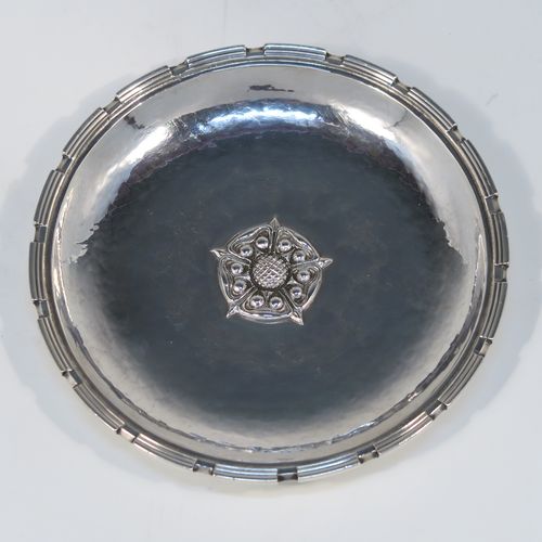 A very beautiful Sterling Silver Arts and Crafts pair of bon-bon dishes, having round hand-hammered bodies, with applied reeded cog borders, central Tudor Rose style bosses, and all sitting on round collet feet. These fantastic silver bon-bon dishes were made by Omar Ramsden of London in 1935. The dimensions of these fine hand-made Arts and Crafts silver dishes are diameter 11.5 cms (4.5 inches), and they weigh approx. 206g (6.6 troy ounces).