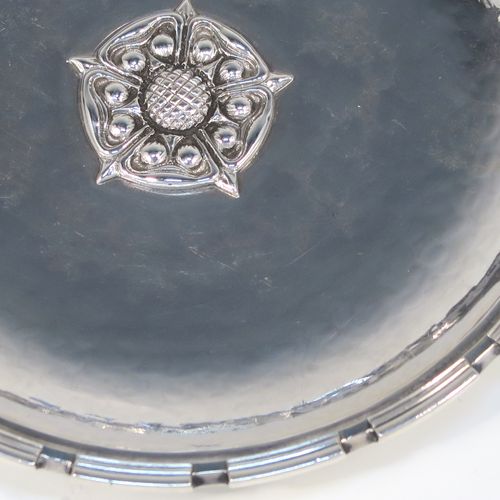 A very beautiful Sterling Silver Arts and Crafts pair of bon-bon dishes, having round hand-hammered bodies, with applied reeded cog borders, central Tudor Rose style bosses, and all sitting on round collet feet. These fantastic silver bon-bon dishes were made by Omar Ramsden of London in 1935. The dimensions of these fine hand-made Arts and Crafts silver dishes are diameter 11.5 cms (4.5 inches), and they weigh approx. 206g (6.6 troy ounces).