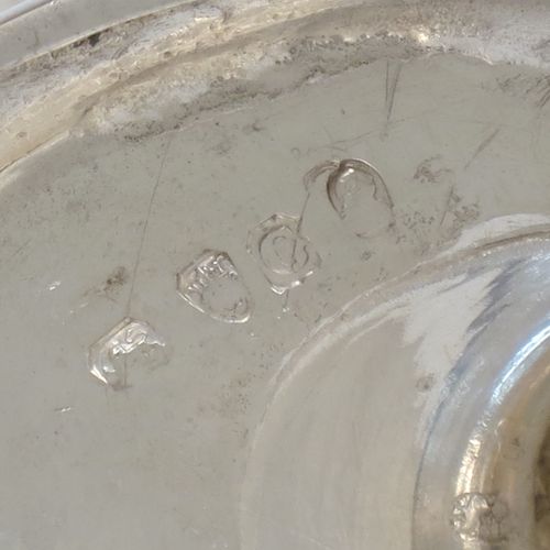 A small but very unusual and pretty Antique Georgian Sterling Silver bon-bon dish or sweet-meat basket, having an oval body with hand-chased half-fluted decoration, a gold-gilt interior, an overhead loop handle, and all sitting on a pedestal foot. Made in London in 1802. The dimensions of this fine hand-made antique bon-bon dish or basket are length 8 cms (3 inches), height 10 cms (4 inches), width 7 cms (2.75 inches), and it weighs approx. 104g (3.4 troy ounces)
