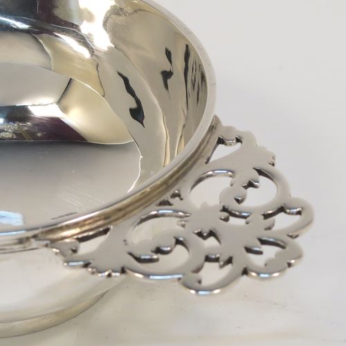 A very handsome Sterling Silver pair of bon-bon dishes, in a Quaich style having plain round bellied bodies, with hand-pierced side-handles, and all sitting on round collet feet. This elegant pair of silver bon-bon dishes were made by Wakely and Wheeler of London in 1996/7. The dimensions of this fine hand-made pair of silver bon-bon dishes are length (inc. handles) 14.5 cms (5.75 inches), diameter 8.5 cms (3.3 inches), height 4 cms (1.5 inches), and they weigh a total of approx. 215g (6.9 troy ounces).   