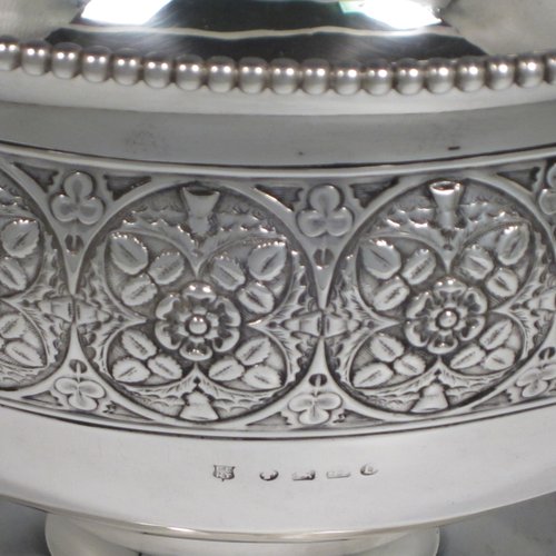 Antique Victorian sterling silver large table rose bowl, having a round body with a hand-chased band of floral decoration, an applied bead-edged border, and all sitting on a pedestal foot. Made by Edgar Finlay & Hugh Taylor of Birmingham in 1888. The dimensions of this fine hand-made silver bowl are diameter 24 cms (9.5 inches), height 16 cms (6.25 inches), and it weighs approx. 752g (24 troy ounces).