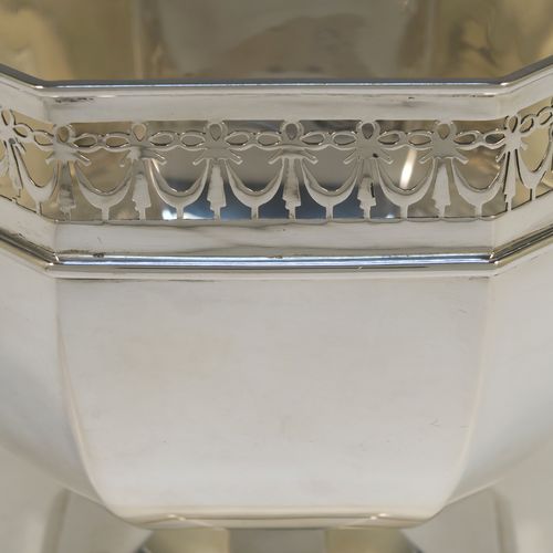 A very handsome Antique Sterling Silver table bowl, having a plain octagonal panelled body, with an applied neoclassical style and hand-pierced top border, and all sitting on a pedestal foot. This beautiful antique silver bowl was made by Charles S. Green and Co., of Birmingham in 1914. The dimensions of this fine hand-made antique silver bowl are width 23 cms (9 inches), height 18.5 cms (7.25 inches), and it weighs approx. 828g (27 troy ounces).