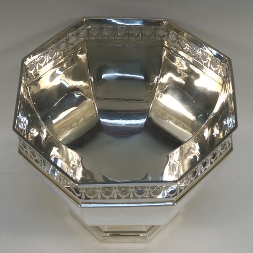 A very handsome Antique Sterling Silver table bowl, having a plain octagonal panelled body, with an applied neoclassical style and hand-pierced top border, and all sitting on a pedestal foot. This beautiful antique silver bowl was made by Charles S. Green and Co., of Birmingham in 1914. The dimensions of this fine hand-made antique silver bowl are width 23 cms (9 inches), height 18.5 cms (7.25 inches), and it weighs approx. 828g (27 troy ounces).