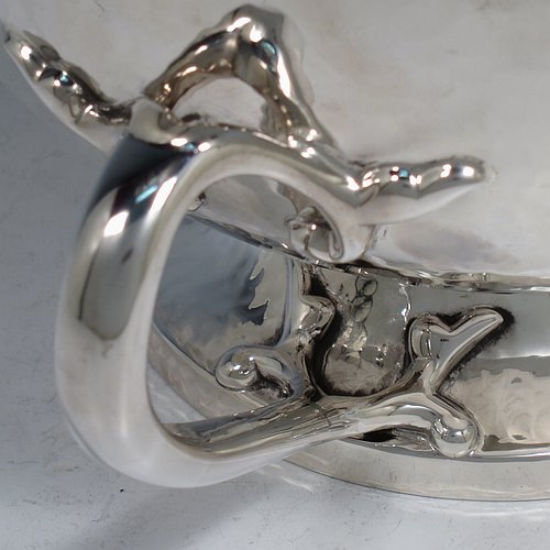An Antique Edwardian heavy Sterling Silver Art Nouveau style table bowl, having a round hand-hammered and bellied body, with three cast scroll and tendril handles attached to a pedestal foot. Made by the Barker Brothers of Chester in 1909. The dimensions of this fine hand-made antique silver bowl are height 15 cms (6 inches), diameter at top of bowl 20 cms (8 inches), and it weighs approx. 44 troy ounces (1,370g).