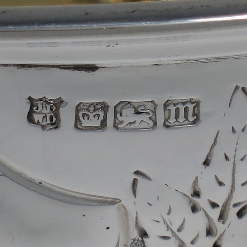 A very pretty Antique Edwardian Sterling Silver large table bowl, having a round body with an applied reeded border and hand-chased floral and scroll decoration, with two vacant cartouches either side, a gold-gilt interior, and all sitting on a stepped pedestal foot. Made by the Deakin Brothers of Sheffield in 1904. The dimensions of this fine hand-made antique silver bowl are diameter 25.5 cms (10 inches), height 15 cms (6 inches), and it weighs approx. 780g (25 troy ounces).