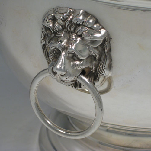 A handsome and large Sterling Silver bowl, having a plain round body, two cast lion-mask ring handles, and sitting on a pedestal foot. This elegant silver table bowl was made in Birmingham in 1972. The dimensions of this fine hand-made silver bowl are diameter 26 cms (10.25 inches), height 19 cms (7.5 inches), and it weighs approx. 1,234g (39.8 troy ounces).