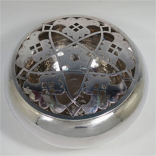 A very unusual and pretty Sterling Silver rose bowl in a a plain round bellied style with hand-hammered decoration finish, an original hand-pierced lift-off removable rose-grill, and all sitting on a collet foot base. Made by the London Assay Office of London in 1975. The dimensions of this fine hand-made silver rose bowl and grill are height 13.5 cms (5.25 inches), diameter 24 cms (9.5 inches), and it weighs approx. 1,195g (38.5 troy ounces).