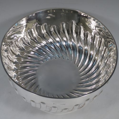 A very nice quality Antique Victorian Sterling Silver Rose bowl, having a round body with hand-chased half swirl-fluted decoration, an applied reeded rim, and sitting on a pedestal foot with matching fluting. Made by John Frank Hall of London in 1895. The dimensions of this fine hand-made antique silver rose bowl are diameter 26 cms (10.25 inches), height 16 cms (6.25 inches), and it weighs approx. 945g (30 troy ounces).