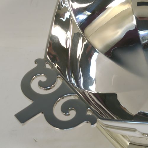 A very handsome Antique Sterling Silver large table bowl, having a plain octagonal panelled body with an applied reeded upper band, together with cast hand-pierced flat scroll handles, and all sitting on a matching pedestal foot. This handsome antique silver bowl was made by Johnson, Walker, and Tolhurst of Sheffield in 1919. The dimensions of this fine hand-made large silver table bowl are diameter 24 cms (9.5 inches), height 15 cms (6 inches), and it weighs approx. 1,269g (41 troy ounces).