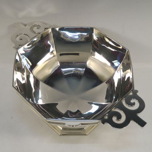 A very handsome Antique Sterling Silver large table bowl, having a plain octagonal panelled body with an applied reeded upper band, together with cast hand-pierced flat scroll handles, and all sitting on a matching pedestal foot. This handsome antique silver bowl was made by Johnson, Walker, and Tolhurst of Sheffield in 1919. The dimensions of this fine hand-made large silver table bowl are diameter 24 cms (9.5 inches), height 15 cms (6 inches), and it weighs approx. 1,269g (41 troy ounces).
