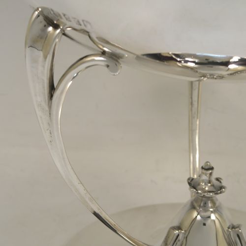 A very handsome Scottish Antique Sterling Silver Art Nouveau style table bowl, having a plain round and bellied body, with three cast scroll and tendril supports attached to a pedestal foot with a central finial. This elegant silver table bowl was made by David and George Edward of Glasgow in 1915. The dimensions of this fine hand-made Art Nouveau Scottish silver bowl are height 27 cms (10.5 inches), diameter at top of bowl 25.5 cms (10 inches), and it weighs approx. 1,535g (49.5 troy ounces).