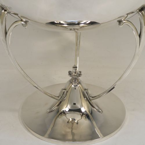 A very handsome Scottish Antique Sterling Silver Art Nouveau style table bowl, having a plain round and bellied body, with three cast scroll and tendril supports attached to a pedestal foot with a central finial. This elegant silver table bowl was made by David and George Edward of Glasgow in 1915. The dimensions of this fine hand-made Art Nouveau Scottish silver bowl are height 27 cms (10.5 inches), diameter at top of bowl 25.5 cms (10 inches), and it weighs approx. 1,535g (49.5 troy ounces).