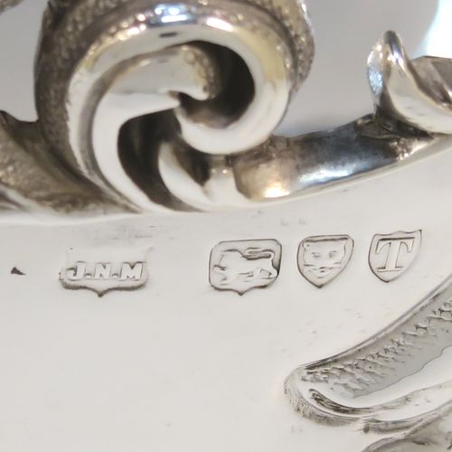 A very pretty and rare Antique Victorian Sterling Silver large oval Rose bowl, having an oval body with hand-chased fluting and garlands of floral decoration, an applied cast scroll top border, and sitting on a pedestal foot with matching decoration. This beautiful antique silver bowl was made by John Newton Mappin of London in 1894. The dimensions of this fine hand-made antique silver large table bowl are length 38 cms (15 inches), width 24 cms (9.5 inches), height 18.5 cms (7.25 inches), and it weighs approx. 1,203g (39 troy ounces).
