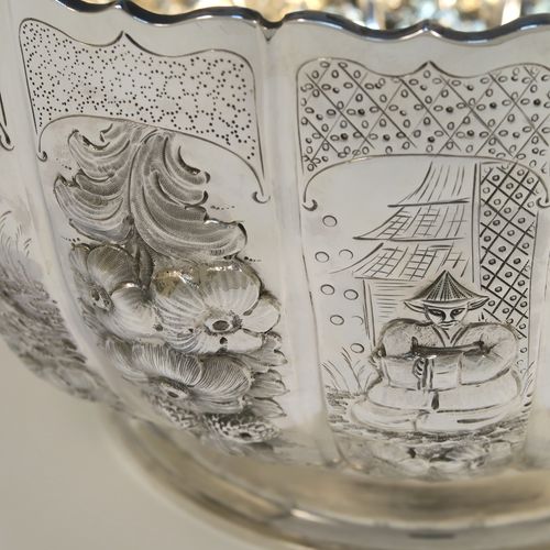 A very unusual and beautiful Antique Victorian Sterling Silver large Rose bowl, having a round panelled body with hand-chased floral and figural decoration, a wavy-edge top border and a gold-gilt interior, and all sitting on a round pedestal foot. This amazing antique silver bowl was made by Francis Boone Thomas of London in 1899. The dimensions of this fine hand-made antique silver large table bowl are diameter 30 cms (11.75 inches), height 17cms (6.75 inches), and it weighs approx. 1,286g (41.5 troy ounces).   