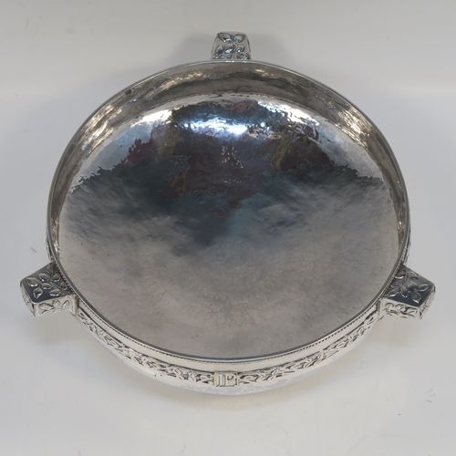 A very unusual and beautiful Antique Sterling Silver Art and Crafts style table bowl, having a round bellied body with hand-hammered decoration, an applied rope-twist top border, together with an applied central band of leaf design work, with three matching side-handles, and all sitting on a pedestal foot. This superb Arts and Crafts style silver table bowl was made by John Sydney Reeve of Birmingham in 1912. The dimensions of this fine hand-made antique silver bowl are height 8.5 cms (3.3 inches), diameter at top of bowl 24 cms (9.5 inches), and it weighs approx. 799g (25.8 troy ounces).