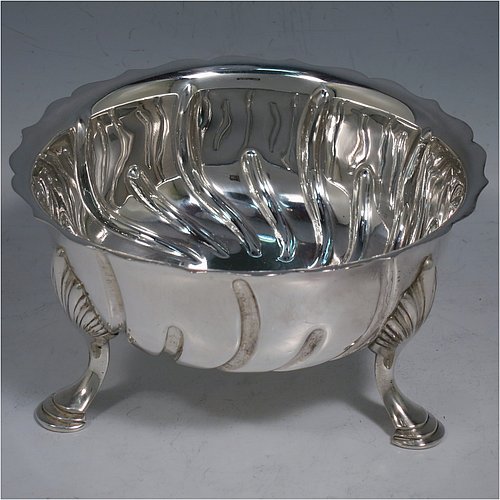 An Antique Victorian Sterling Silver bowl, having a round body, with hand-chased swirl half-fluting, a shaped pie-crust border, and all sitting on three cast hoof feet with shell shoulders. Made by the Barnard Brothers of London in 1888. The dimensions of this fine hand-made antique silver bowl are height 7 cms (2.75 inches), diameter 13 cms (5.25 inches), and it weighs approx. 195g (6.3 troy ounces).    