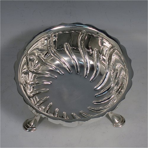 An Antique Victorian Sterling Silver bowl, having a round body, with hand-chased swirl half-fluting, a shaped pie-crust border, and all sitting on three cast hoof feet with shell shoulders. Made by the Barnard Brothers of London in 1888. The dimensions of this fine hand-made antique silver bowl are height 7 cms (2.75 inches), diameter 13 cms (5.25 inches), and it weighs approx. 195g (6.3 troy ounces).