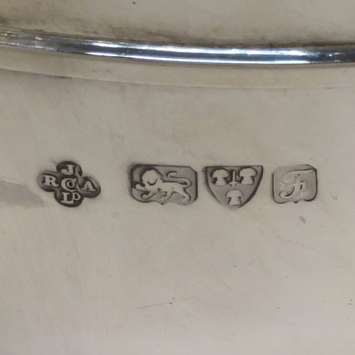 A handsome pair of Antique Edwardian Sterling Silver Monteith style bowls with rose grills, having round bodies with applied scroll borders, with cast lion-mask handles either side, and all sitting on pedestal feet. These elegant silver rose bowls were made by Jays of Chester in 1906. The dimensions of these fine hand-made antique silver Montieth rose bowls are diameter 14 cms (5.5 inches), height 11 cms (4.25 inches), and they weigh a total of approx. 800g (25.8 troy ounces). Please note that this item is part-crested.