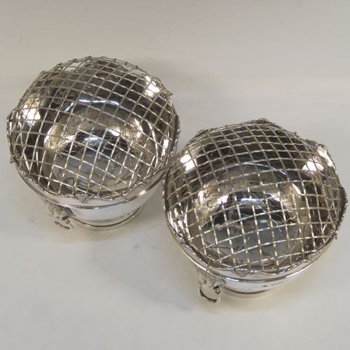 A handsome pair of Antique Edwardian Sterling Silver Monteith style bowls with rose grills, having round bodies with applied scroll borders, with cast lion-mask handles either side, and all sitting on pedestal feet. These elegant silver rose bowls were made by Jays of Chester in 1906. The dimensions of these fine hand-made antique silver Montieth rose bowls are diameter 14 cms (5.5 inches), height 11 cms (4.25 inches), and they weigh a total of approx. 800g (25.8 troy ounces). Please note that this item is part-crested.