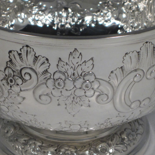 Antique Edwardian sterling silver rose bowl, having a round body with hand-chased floral decoration, two vacant cartouches, and sitting on a pedestal foot. Made by Elkington and Co., of Birmingham in 1903. The dimensions of this fine hand-made silver rose bowl are height 11 cms (4.25 inches), diameter 15 cms (6 inches), and the total weight is approx. 326g (10.5 troy ounces).