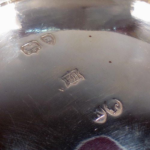 A very pretty Antique Victorian Sterling Silver bowl, having a round body with hand-chased swags of floral and scroll decoration over a lower band of vertical fluting, with an applied bead-edged border, and all sitting on a collet foot. Made by Edward Hutton of London in 1885. The dimensions of this fine hand-made antique silver bowl are diameter 11 cms (4.3 inches), height 6 cms (2.3 inches), and it weighs approx. 140g (4.5 troy ounces).