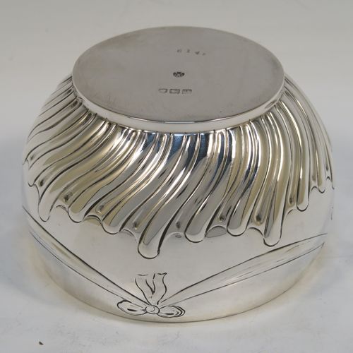A very pretty Antique Victorian Sterling Silver small Rose bowl, having a round bellied body with hand-chased bows, swags, and half swirl-fluted decoration, and sitting on a flat base. This beautiful antique silver rose bowl was made by the Barnard Brothers of London in 1896. The dimensions of this fine hand-made silver bowl are height 7.5 cms (3 inches), diameter 12 cms (4.75 inches), and it weighs approx. 220g (7 troy ounces).