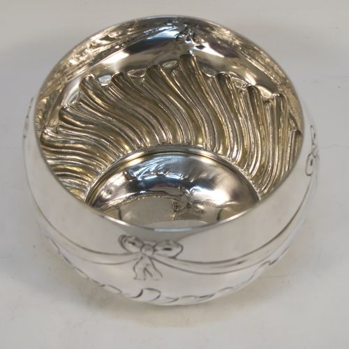 A very pretty Antique Victorian Sterling Silver small Rose bowl, having a round bellied body with hand-chased bows, swags, and half swirl-fluted decoration, and sitting on a flat base. This beautiful antique silver rose bowl was made by the Barnard Brothers of London in 1896. The dimensions of this fine hand-made silver bowl are height 7.5 cms (3 inches), diameter 12 cms (4.75 inches), and it weighs approx. 220g (7 troy ounces).