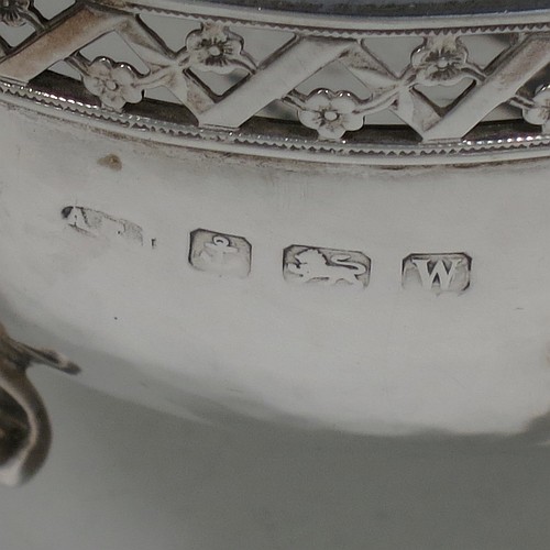 A very unusual and pretty pair of Arts and Crafts style Sterling Silver bowls, having oval bodies with hand-hammered decoration, with hand-pierced and floral borders, two scroll side-handles with flat thumb-pieces, and all sitting on four cast goat hoof feet. Made by A. E. Jones of Birmingham in 1921. The dimensions of these fine hand-made Arts and Crafts silver oval bowls are length 21 cms (8.25 inches), width 11 cms (4.3 inches), height 6.5 cms (2.5 inches), and they weigh a total of approx. 470g (15.2 troy ounces).